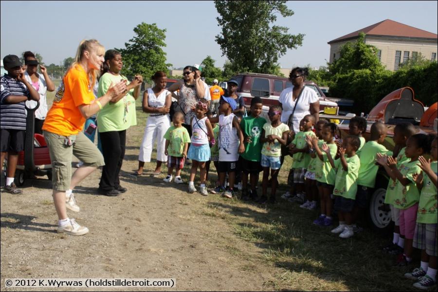 Volunteer Linda gets the kids revved up for their tour
